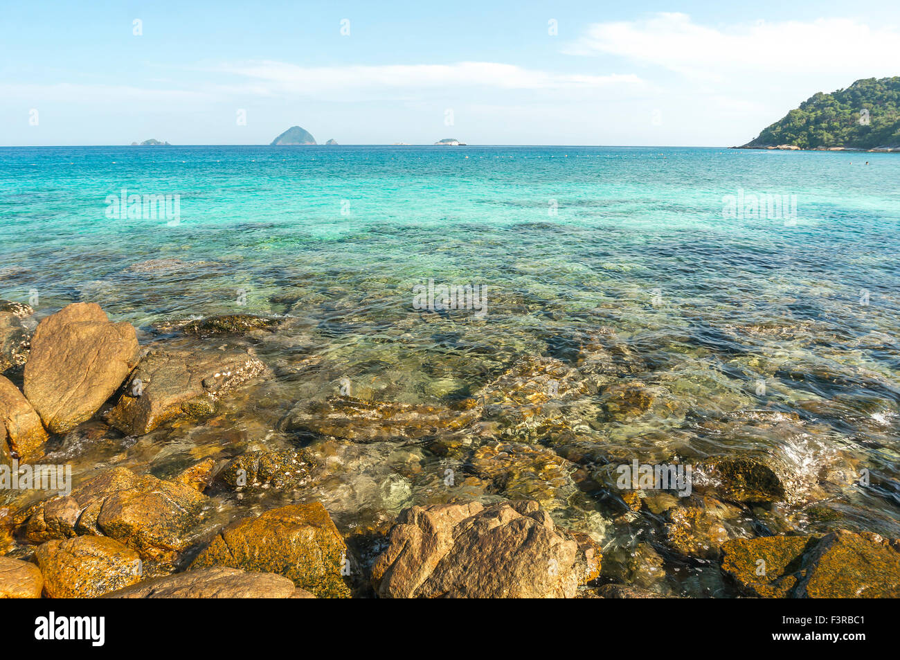 Beach rock with clear water Stock Photo - Alamy