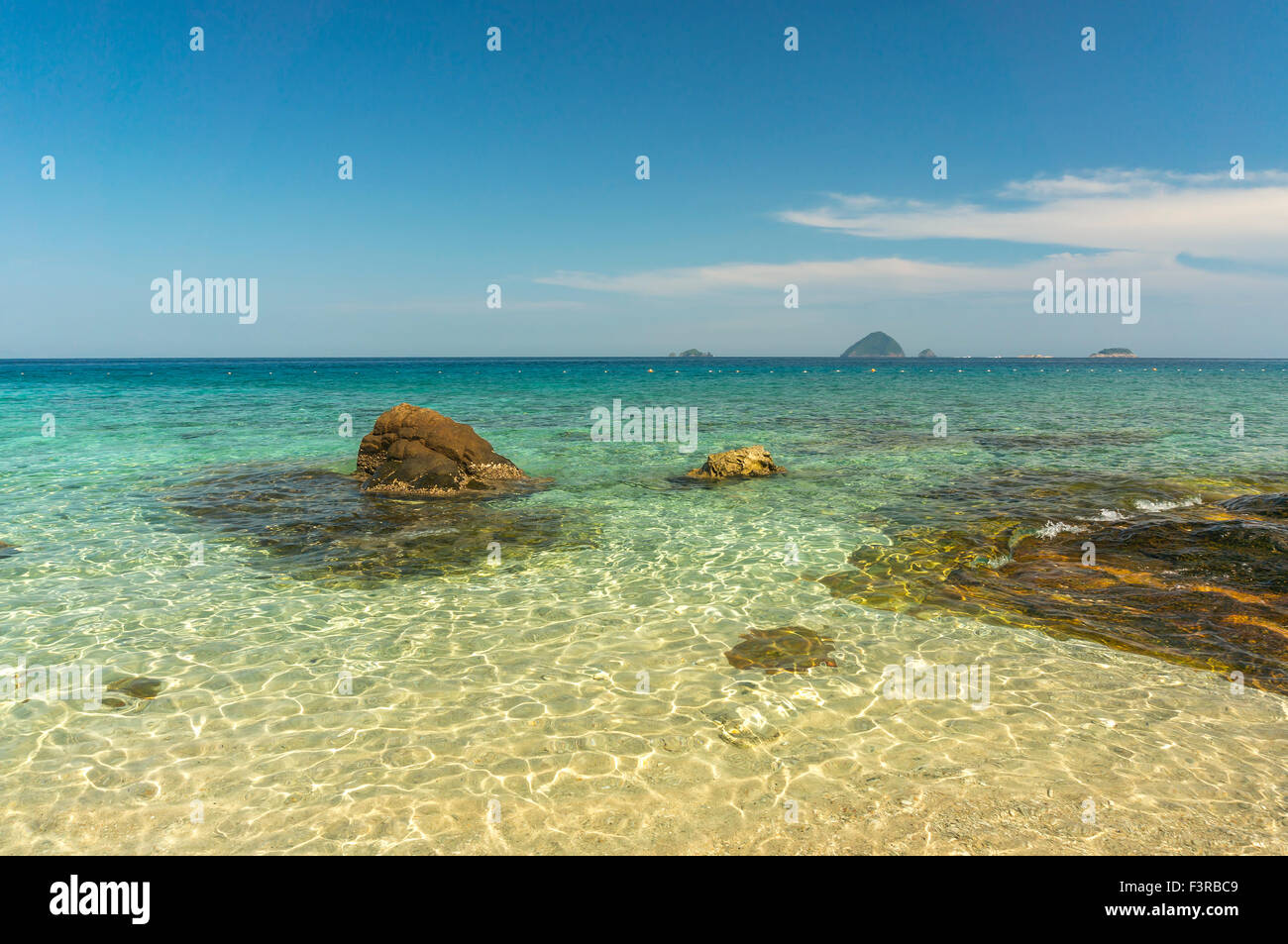 Beach rock with clear water Stock Photo - Alamy