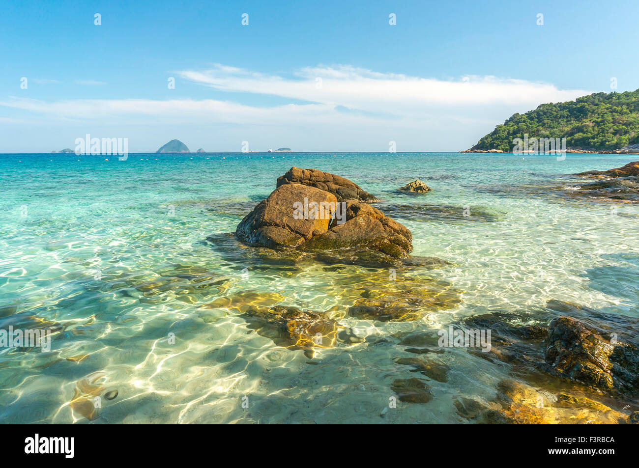 Beach rock with clear water Stock Photo - Alamy
