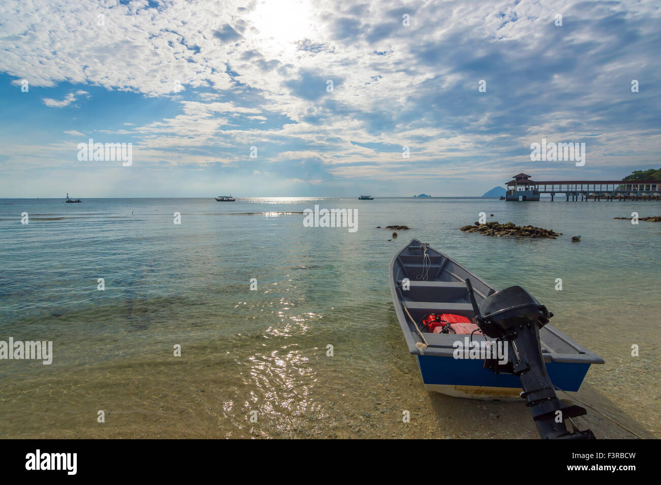 Boat with clear water and blue skies Stock Photo - Alamy