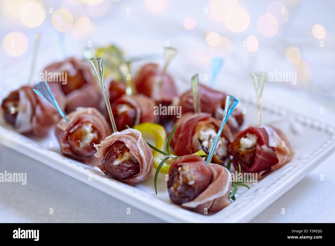 Dates stuffed cheese and wrapped prosciutto Stock Photo Alamy