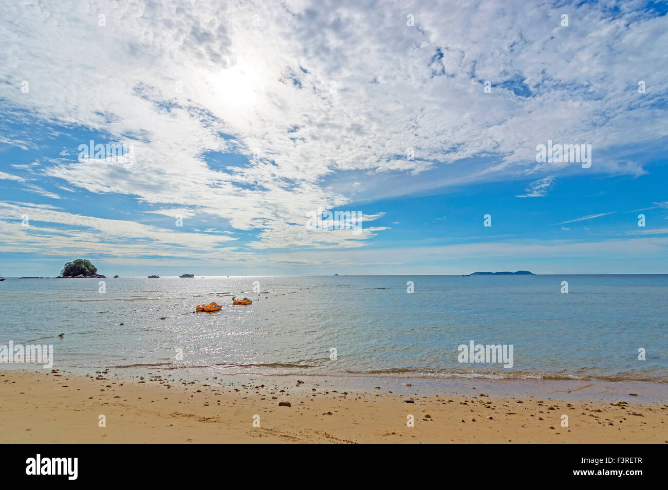 Beach with blue skies Stock Photo - Alamy