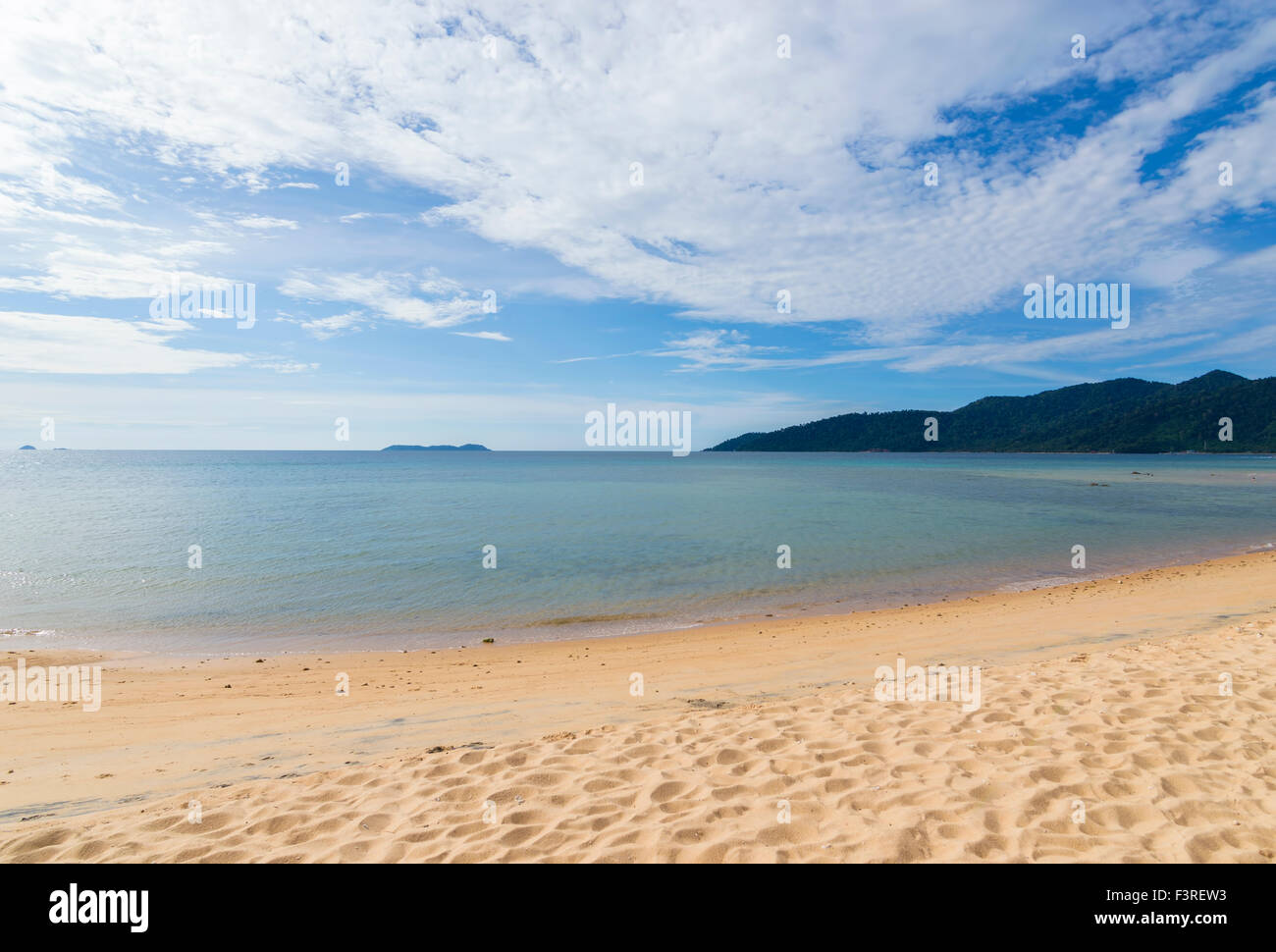 Beach with blue skies Stock Photo - Alamy