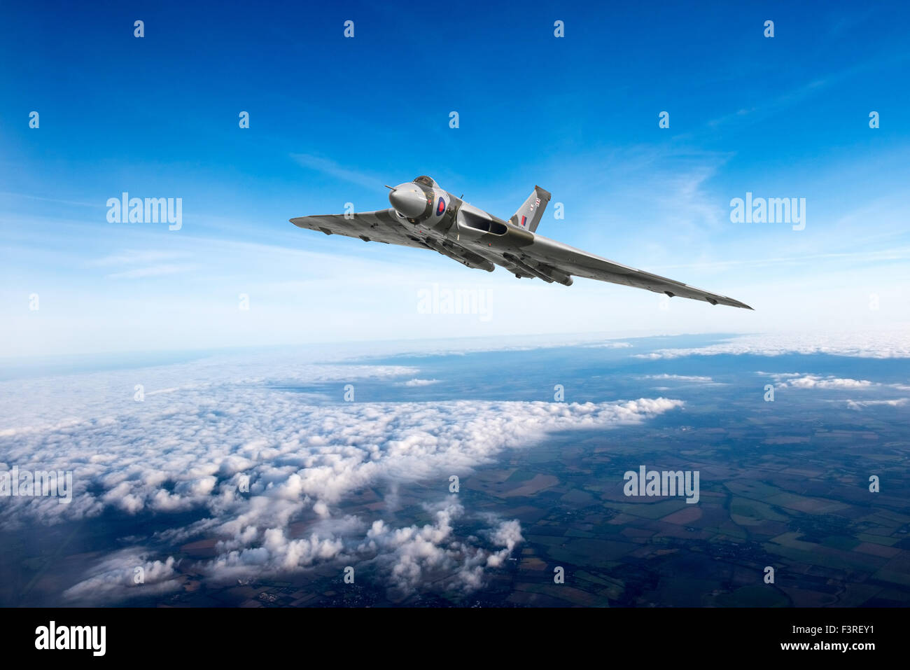 A depiction of an Avro Vulcan delta wing strategic bomber in the skies over the British countryside. Stock Photo
