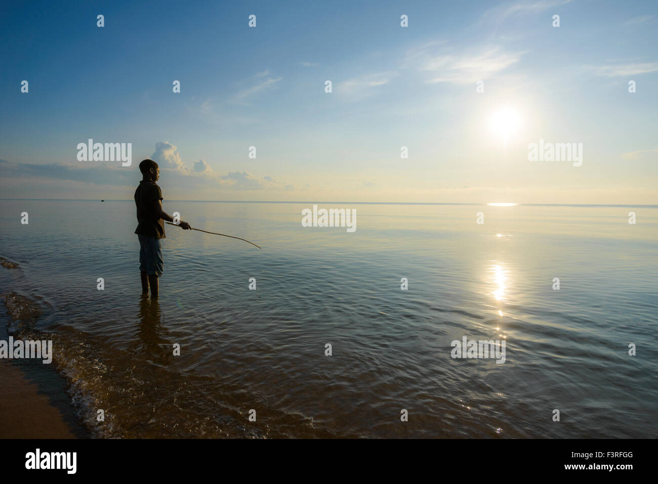 Boy is fishing on Lake Malawi, Malawi, Africa Stock Photo