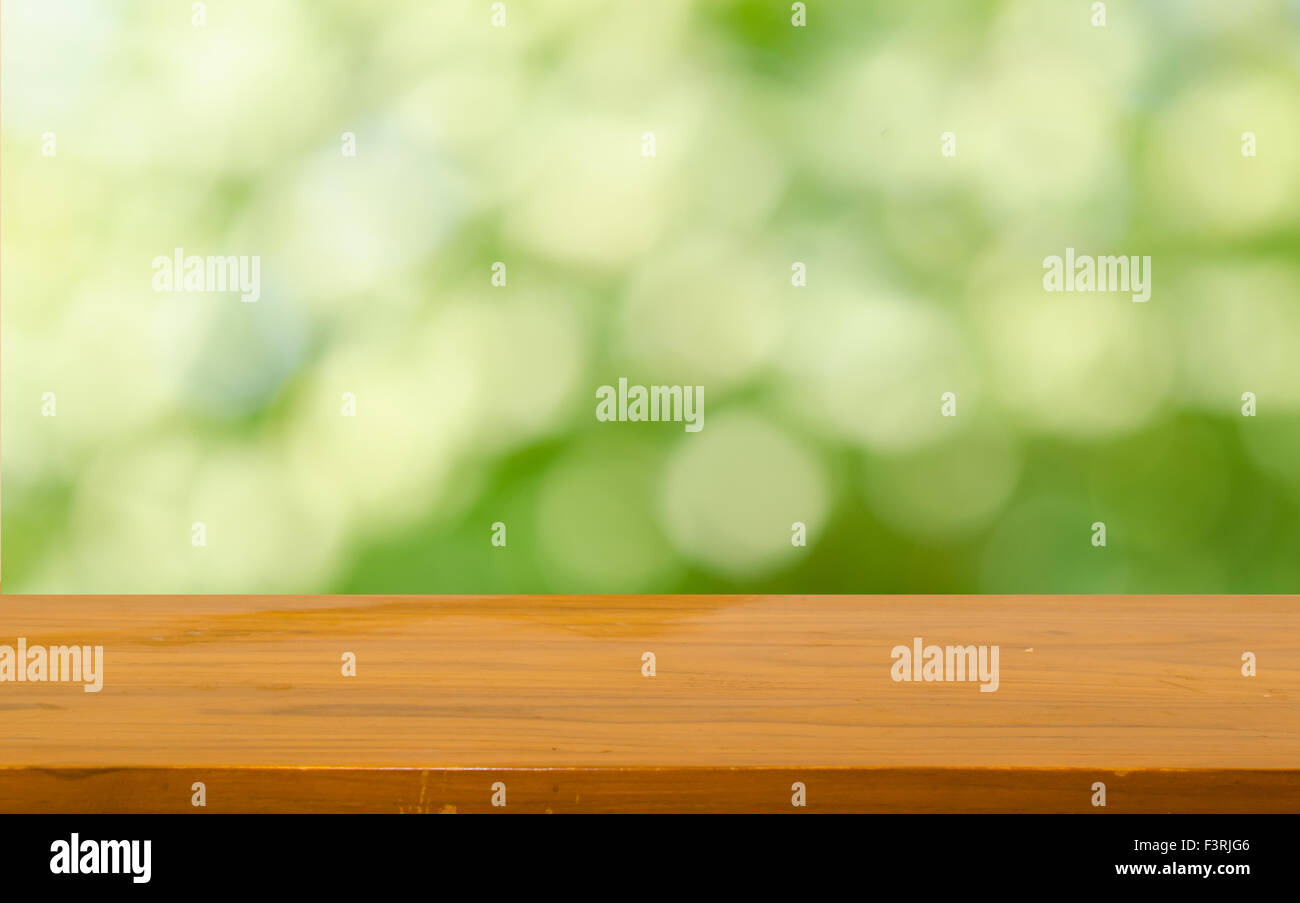 Wood table top on bokeh green background Stock Photo - Alamy