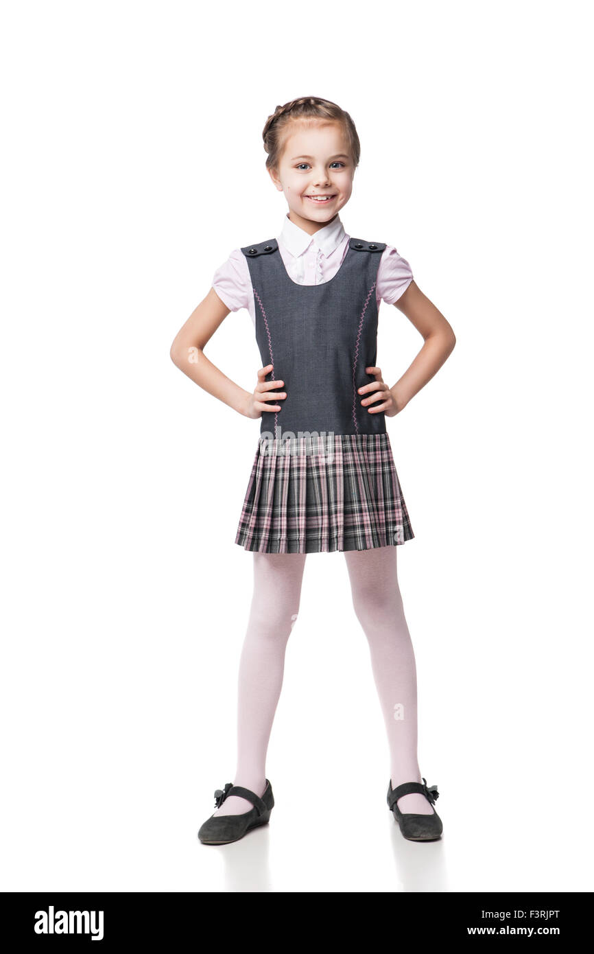 Beautiful little girl in school uniform isolated on white Stock Photo