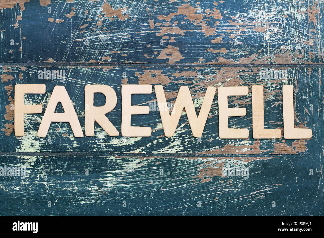 Word farewell written on rustic wooden surface Stock Photo