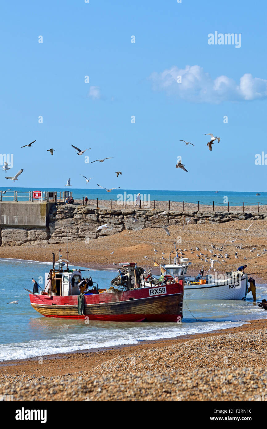 Hastings, East Sussex, England, UK. Fishing boats landing the catch on the beach Stock Photo