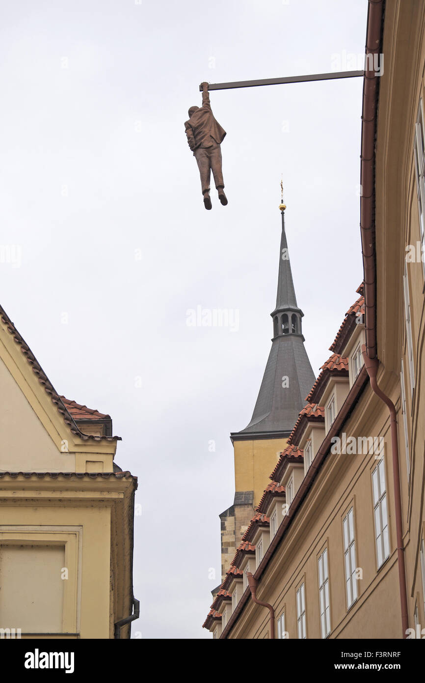 Sculpture of a man hanging from a beam, above a backstreet, Old Town, Prague, Czech Republic. Stock Photo