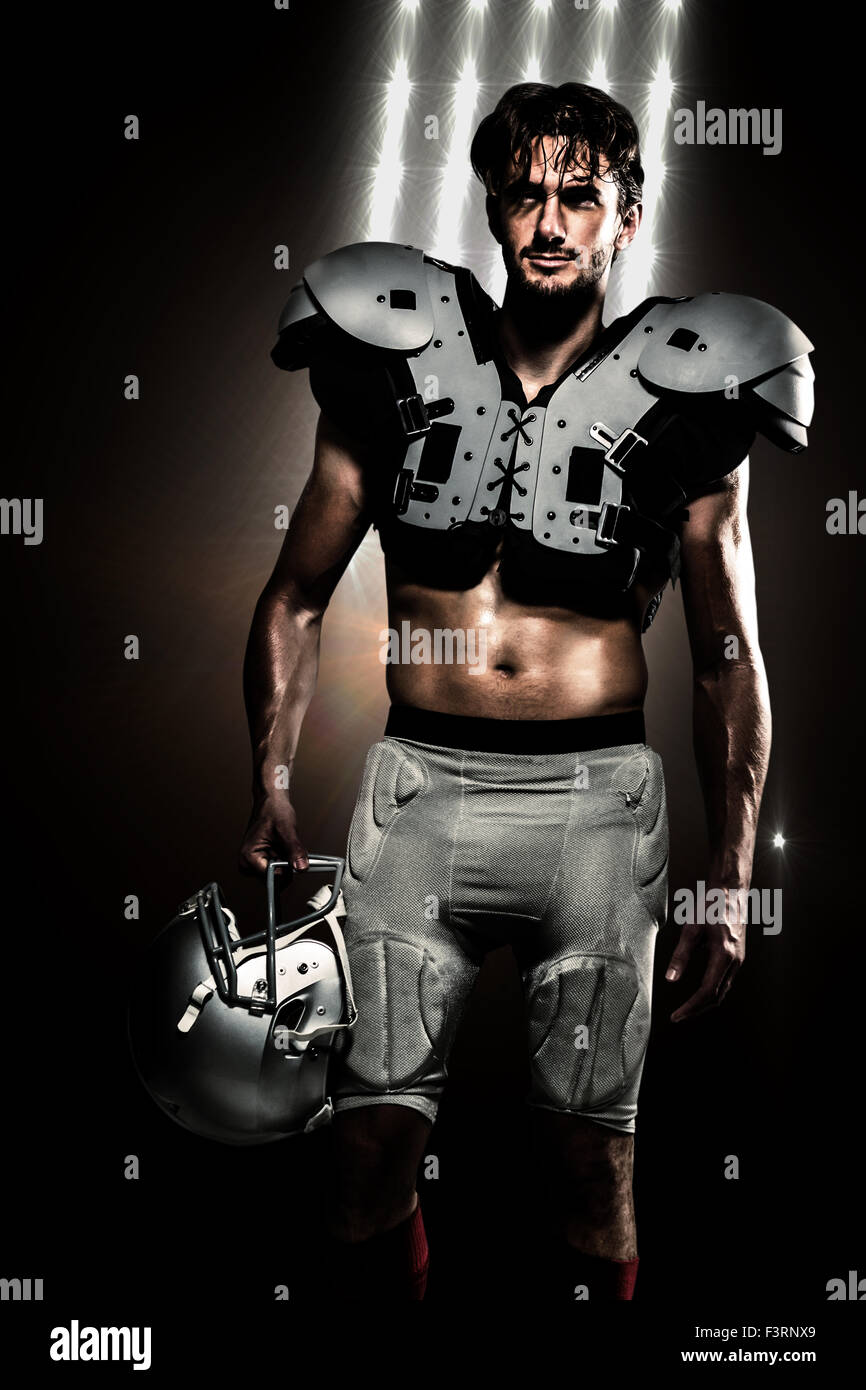 Composite image of shirtless american football player with padding