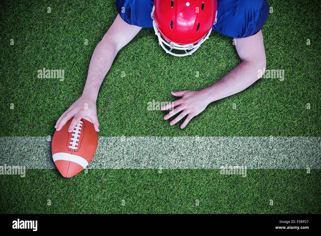 Composite image of american football player scoring a touchdown Stock Photo