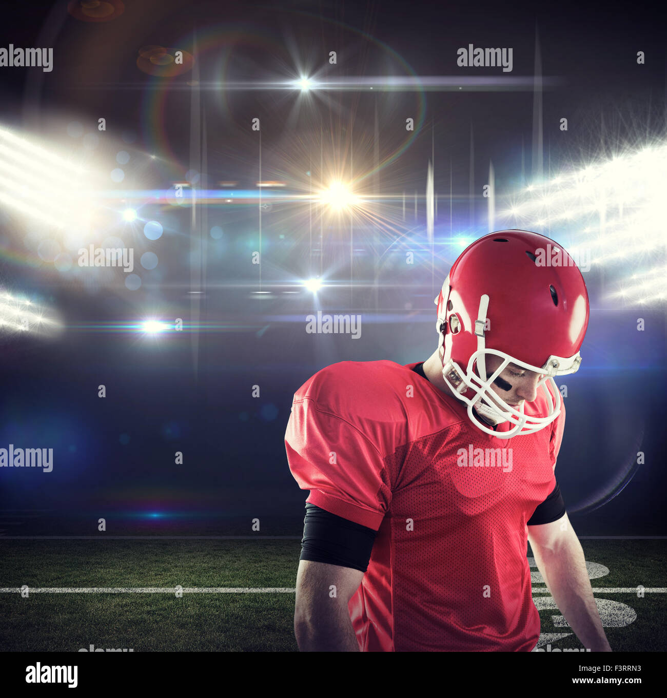 Composite image of american football player focusing Stock Photo