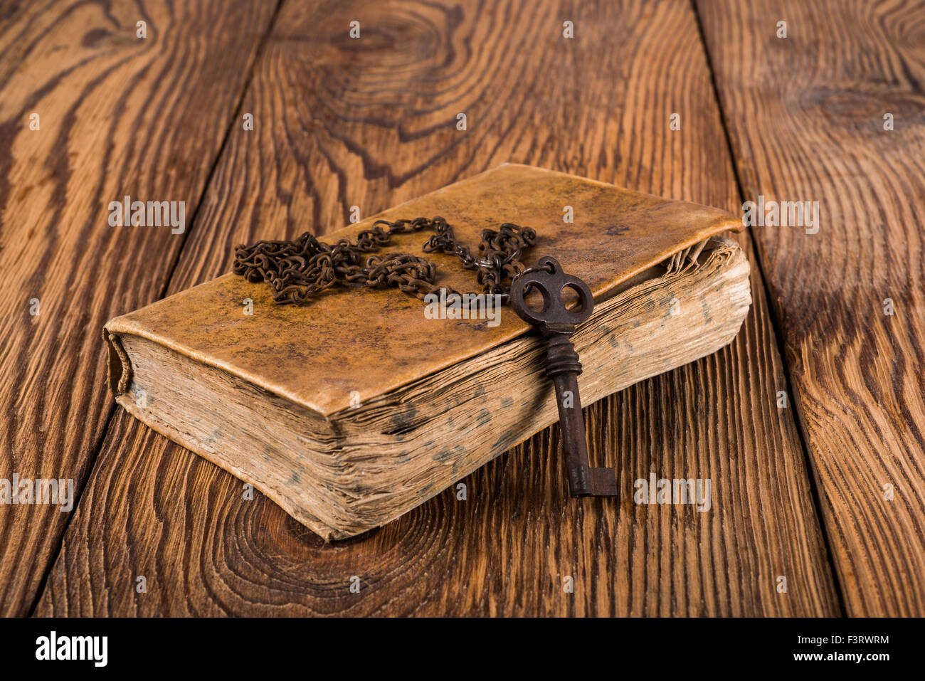 Old key with chain on an book Stock Photo