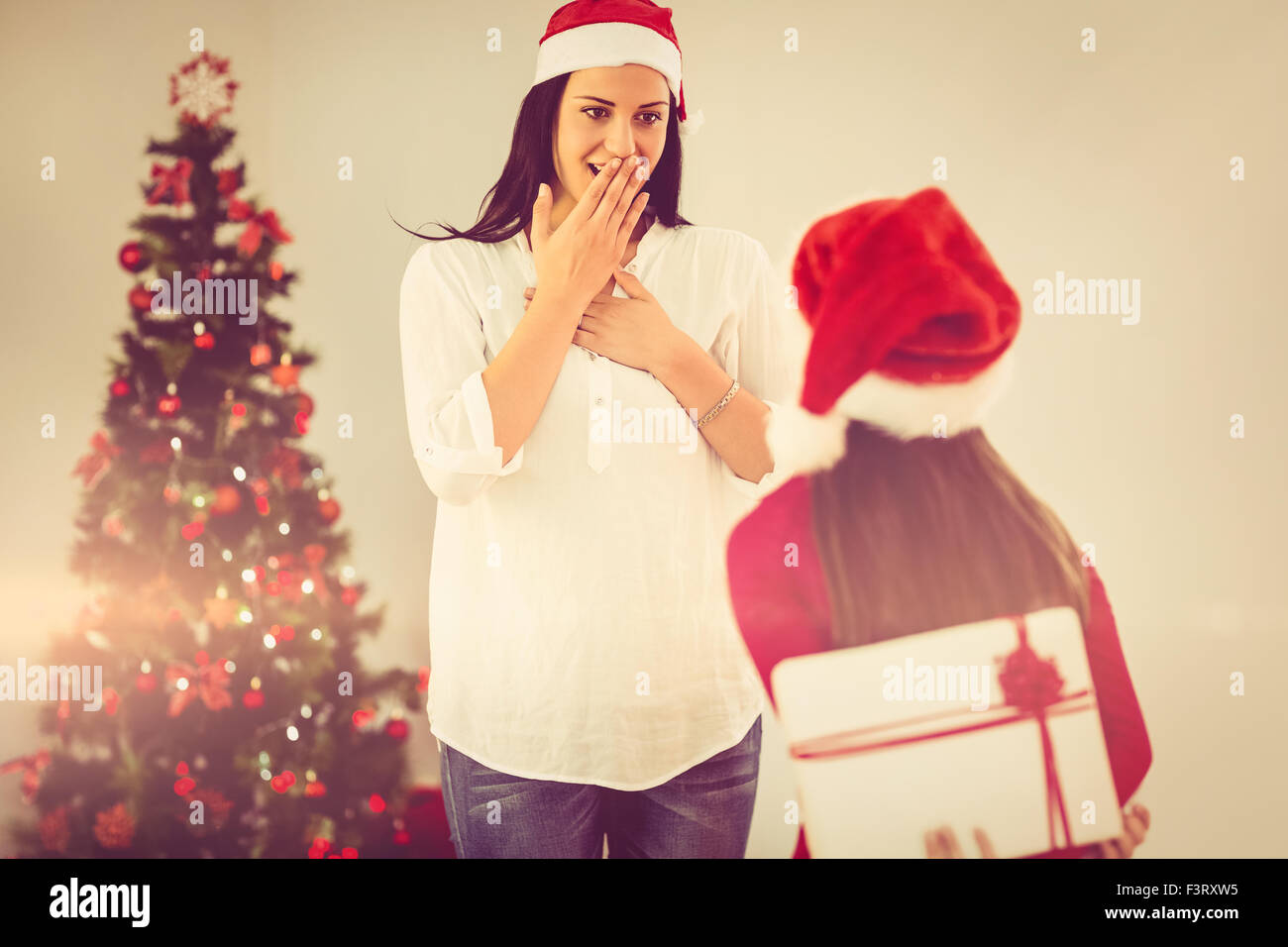 Daughter surprising her mother with christmas gift Stock Photo