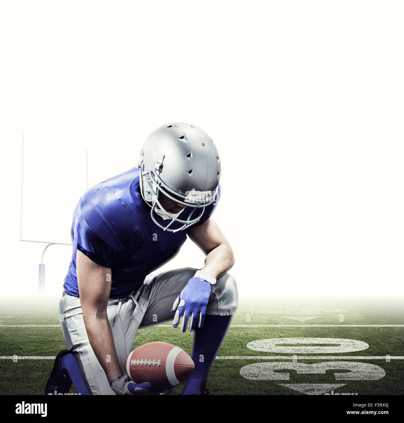 Composite image of american football player kneeling while holding ball