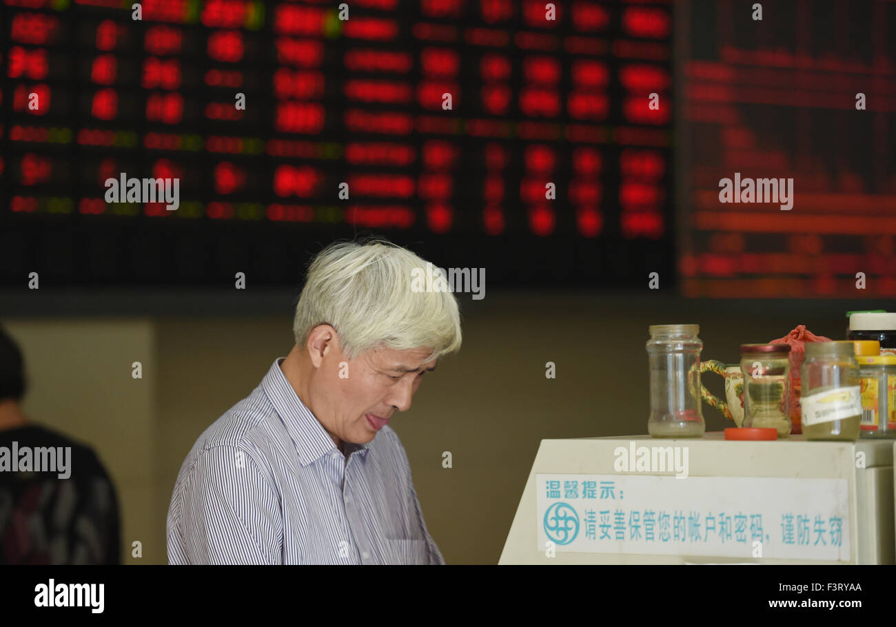 Hangzhou, China. 12th October, 2015. A citizen is seen at a stocks market in Hangzhou, east China's Zhejiang Province, Oct. 12, 2015. The benchmark Shanghai Composite Index was up 3.28 percent to end at 3,287.66 points on Monday. The Shenzhen Component Index rose 4 percent to close at 10,961.36 points. Credit:  Xinhua/Alamy Live News Stock Photo