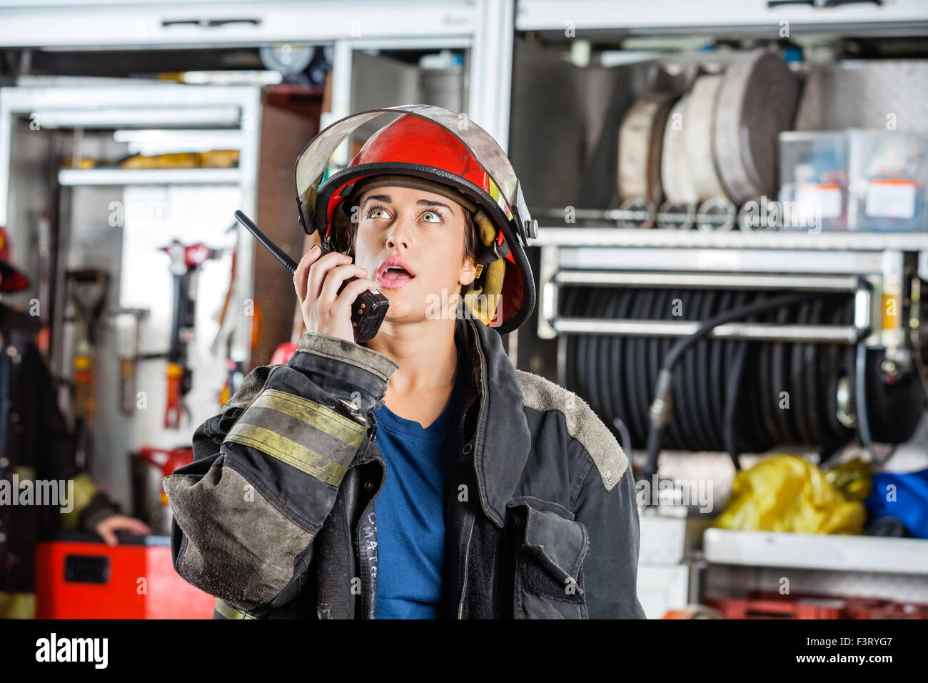 Confident Female Firefighter Using Walkie Talkie Stock Photo - Alamy