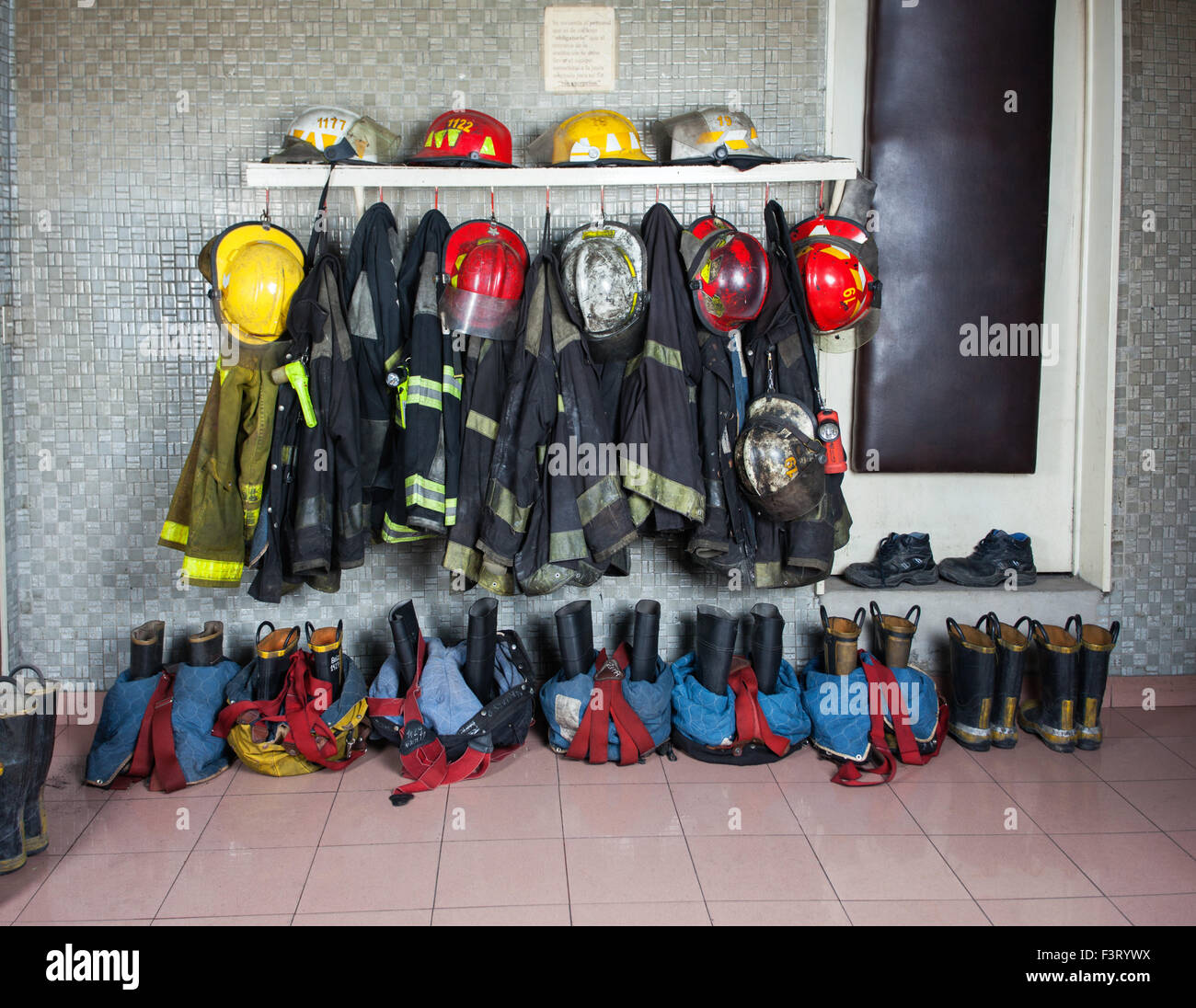 Firefighter Suits Arranged At Fire Station Stock Photo