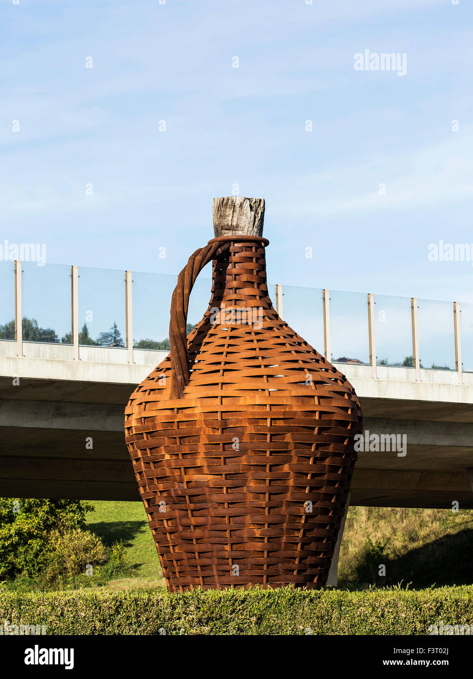 Big bottle for wine, placed near a road.. Stock Photo