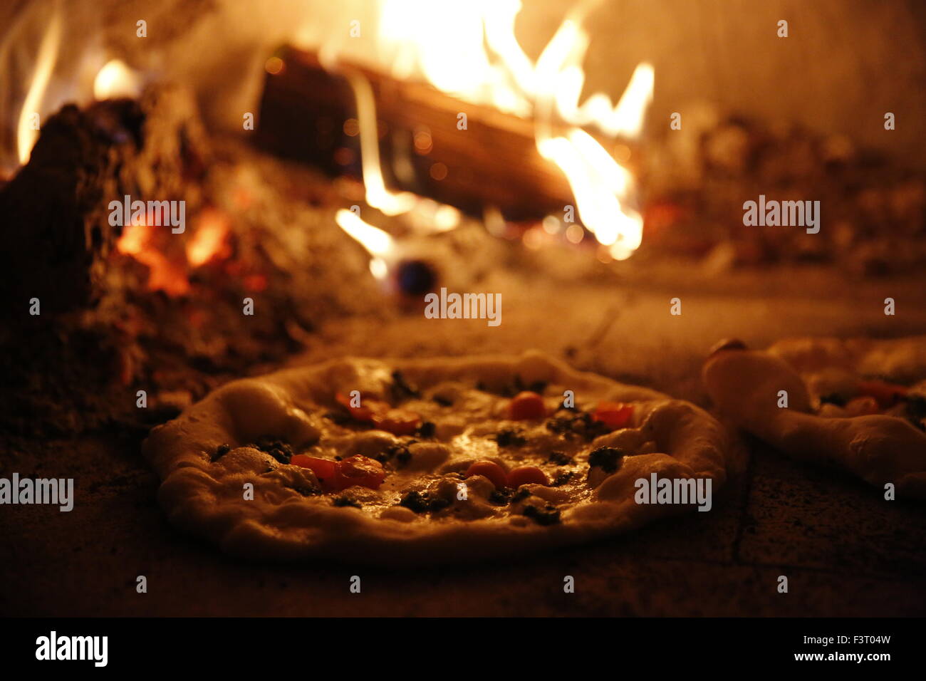 Wood fired pizza being made in alley by street vendor King Dough Pizza