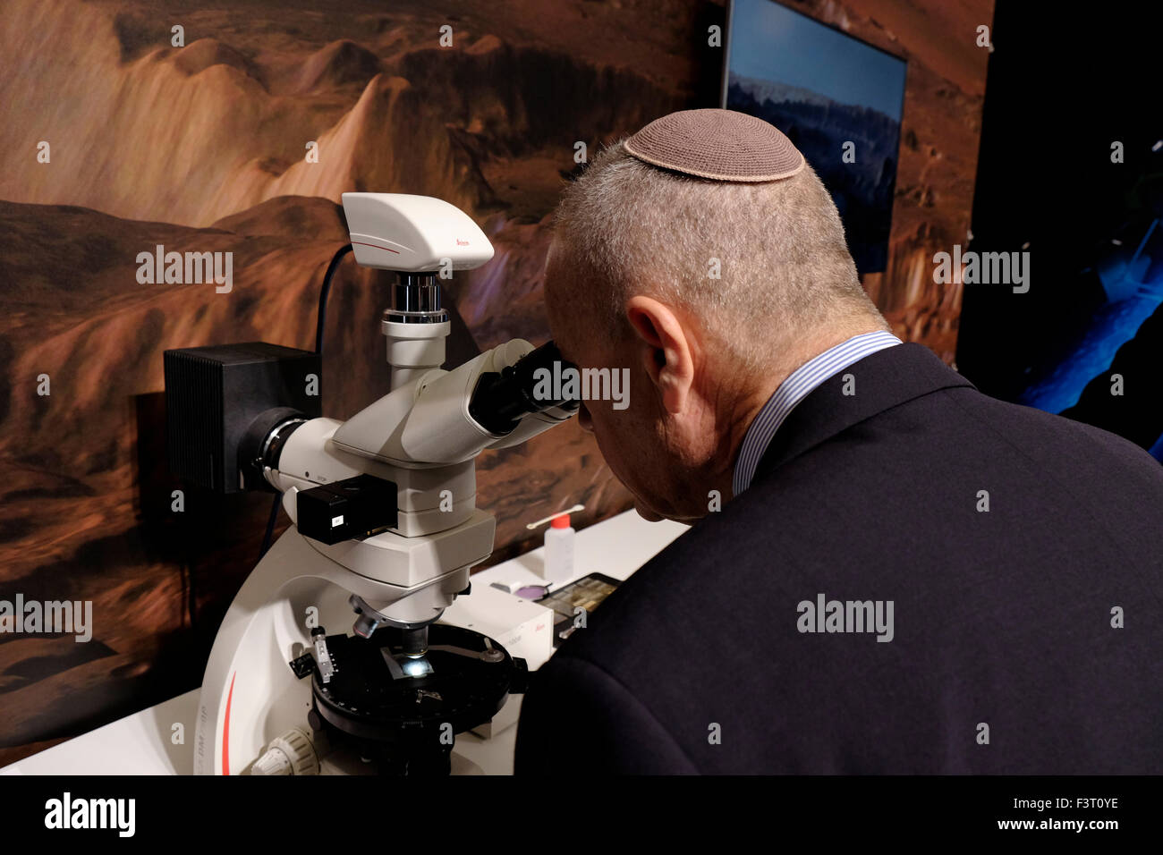 Jerusalem, Israel. 12th October, 2015. An Israeli Jewish visitor at the German Institute of Planetary research booth at the IAC International Astronautical Congress in Jerusalem, Israel on 12 October 2015. Israel’s space sector has significantly developed and expanded recent years in diverse areas of interest. Israeli President Reuven Rivlin, along with representatives of Google and Spacell an Israeli space engineering company, announced last week that Israel plans to land a private spacecraft on the moon before the end of 2017. Credit:  Eddie Gerald/Alamy Live News Stock Photo