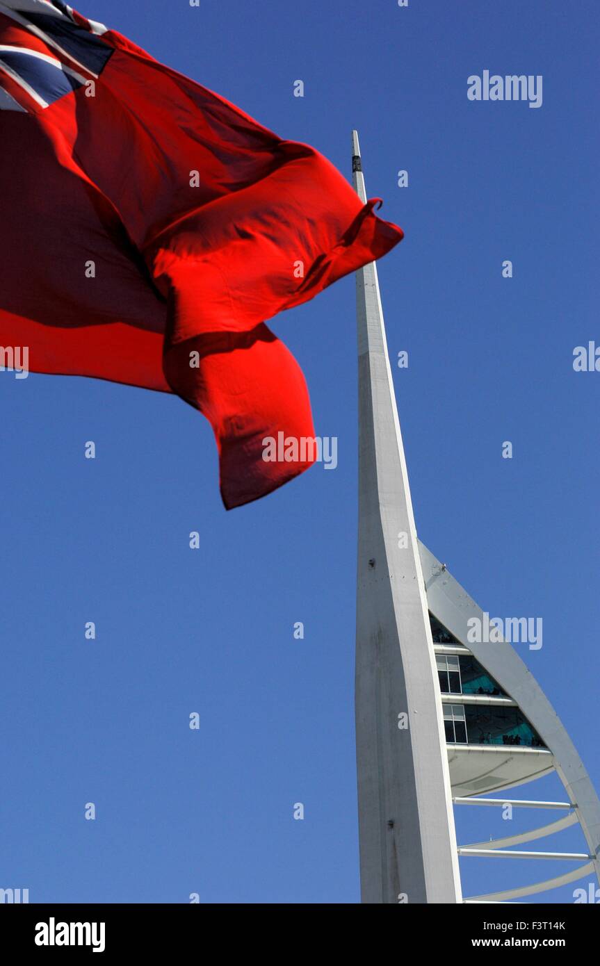 AJAXNETPHOTO.  PORTSMOUTH, ENGLAND.  - RED ENSIGN FLUTTERS FROM THE STERN OF HMS WARRIOR WITH THE MILLENIUM SPINNAKER TOWER IN THE BACKGROUND. PHOTO:JONATHAN EASTLAND/AJAX REF:D150406 5277 Stock Photo