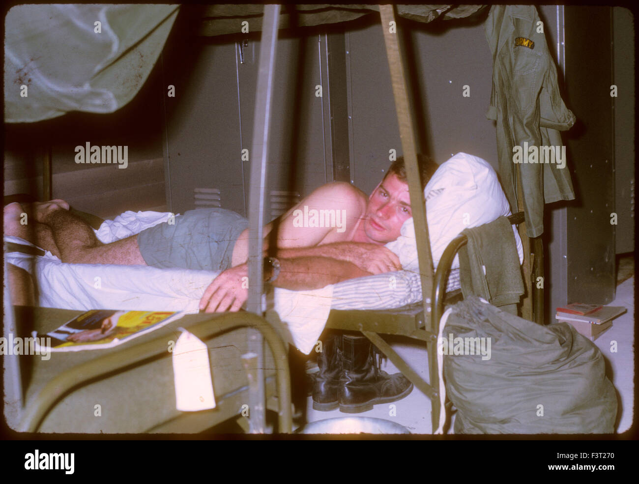 An American solider rests in a bunk in a rent in Cam Rahn Bay during the Vietnam War. Stock Photo