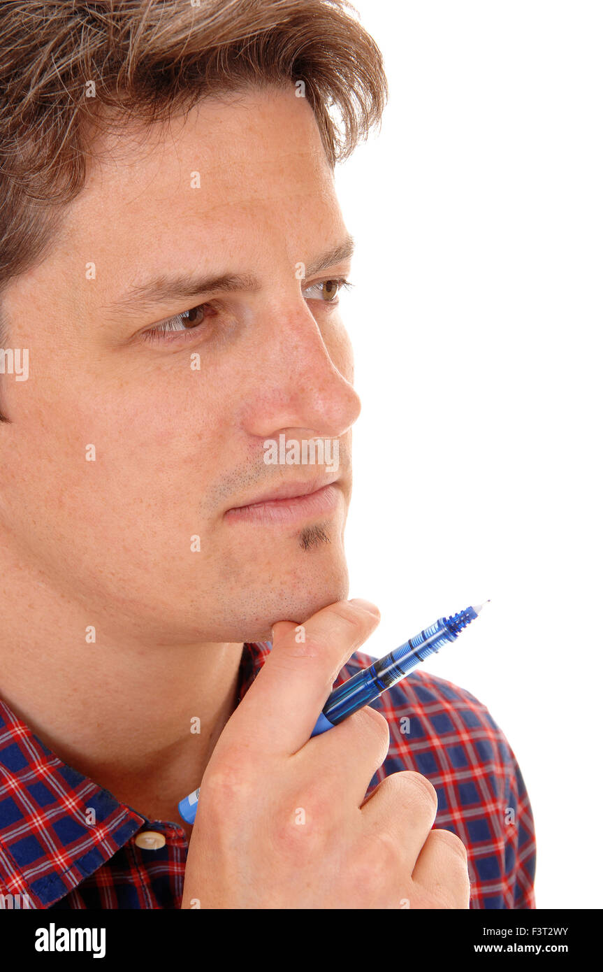 A closeup picture of a young man, holding a blue pen, in deep thoughts, isolated for white background. Stock Photo