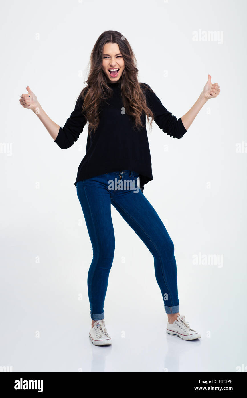 Full length portrait of a cheerful casual woman showing thumbs up ...