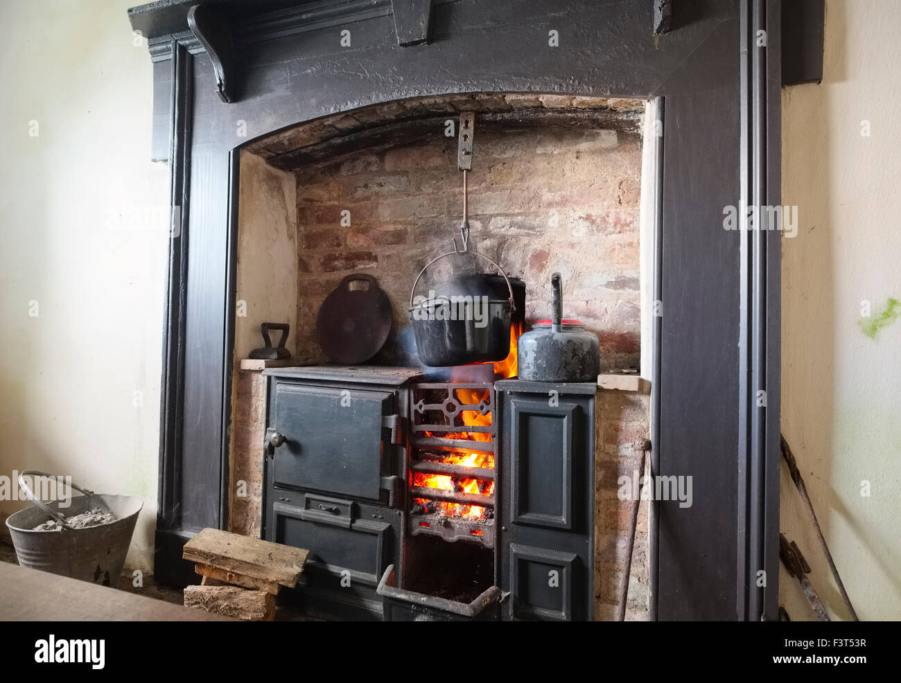 A roaring fire in a cast iron range at a restored miners' cottage at