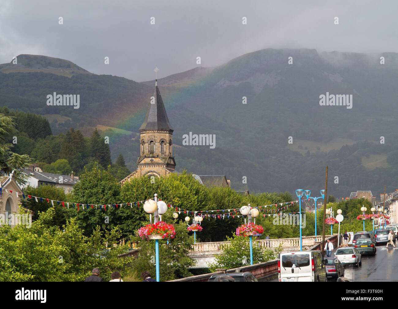 A rainbow over the spa town of La Bourboule, Sancy, Puy de Dome, France - extinct volcanoes in the background Stock Photo