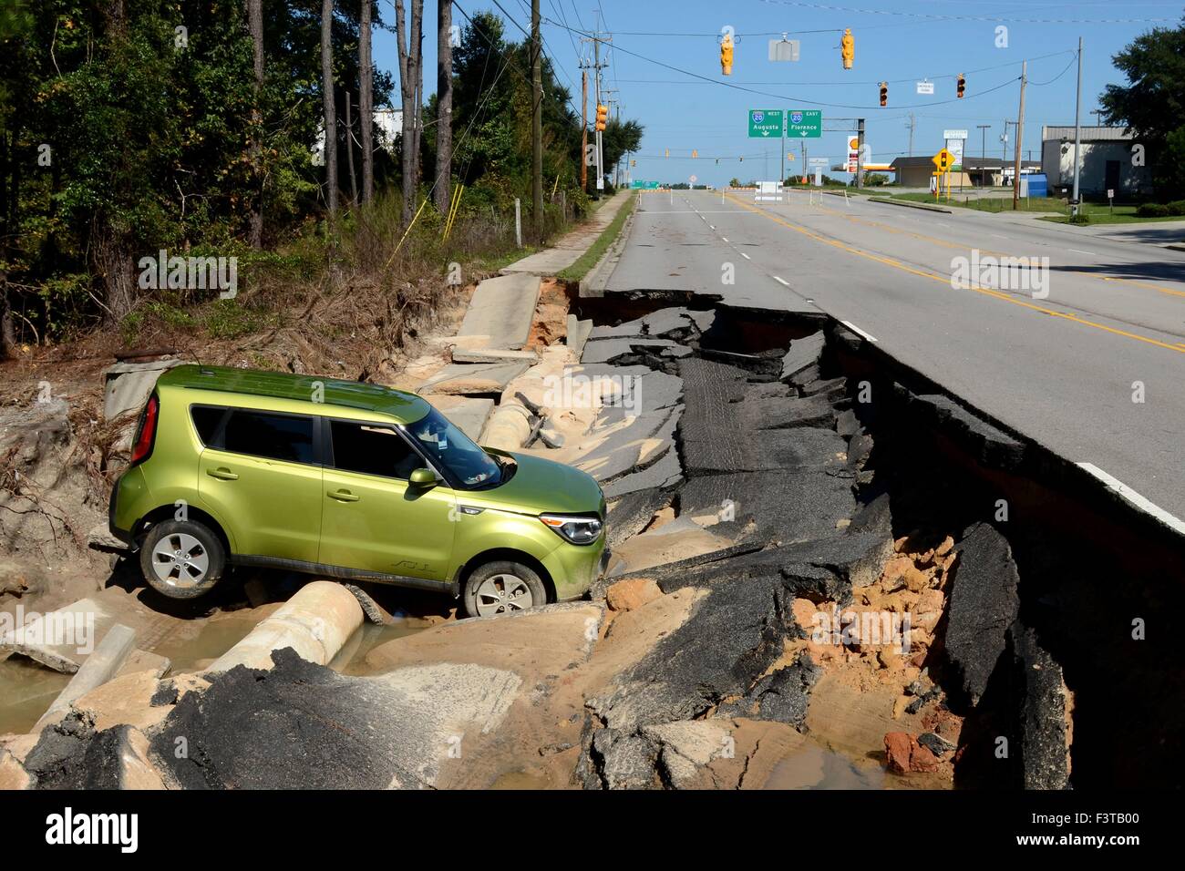 A vehicle sits in debris after the road collapsed in the state capital following record setting rains October 11, 2015 in Columbia, South Carolina. Large parts of South Carolina suffered from record setting rains that flooded large portions of the state. Stock Photo