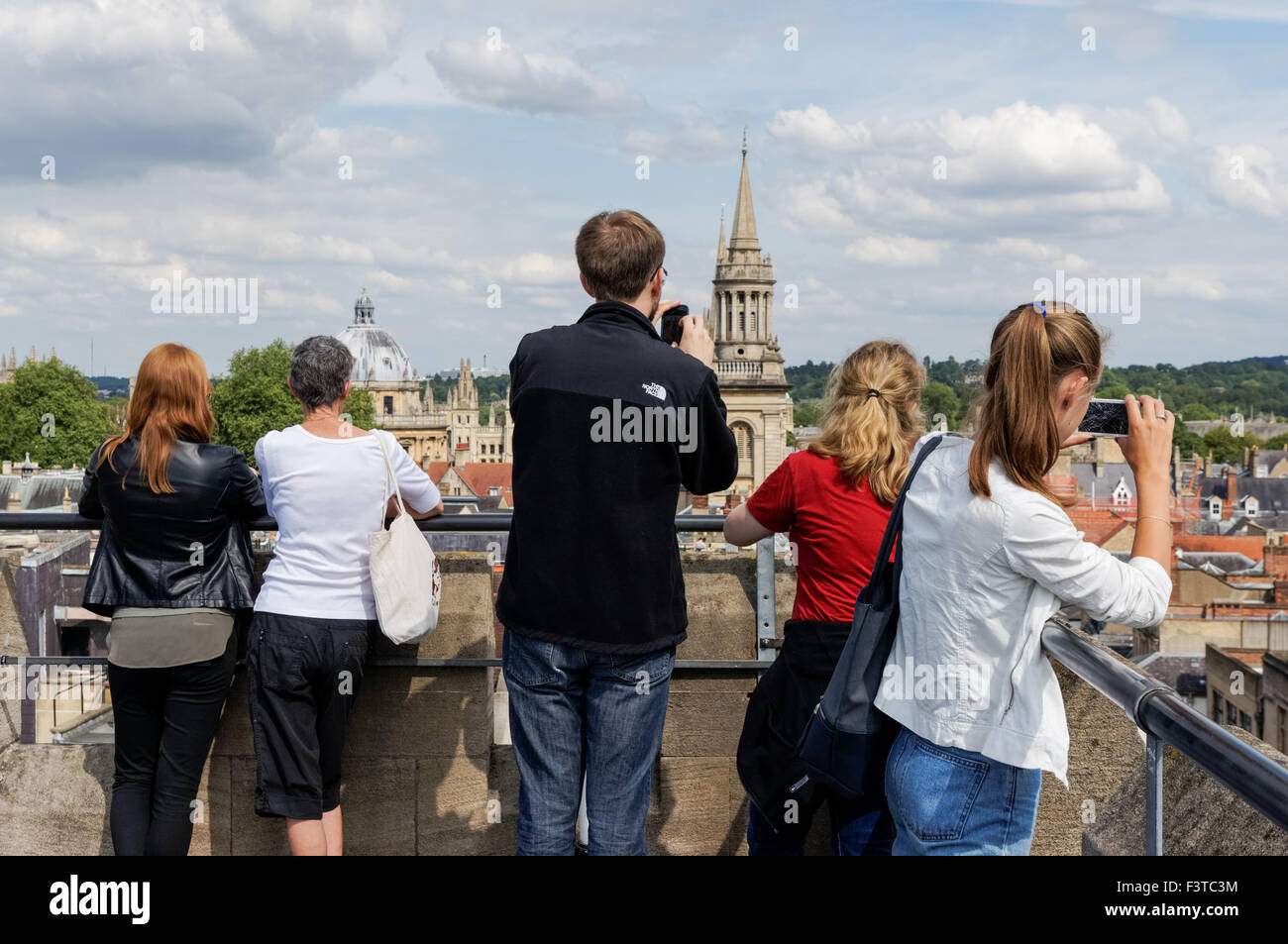 Tourists enjoying view from the top of St Martin's Tower, Carfax Tower in Oxford Oxfordshire England United Kingdom UK Stock Photo