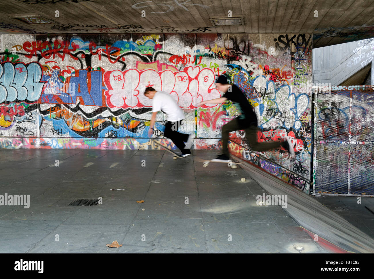 Skateboarders riding in a skate park Stock Photo