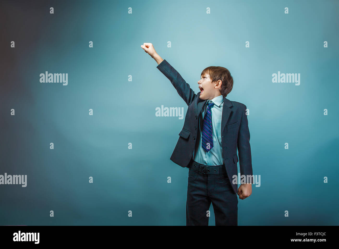 European appearance teenager boy in a business suit raised his h Stock Photo