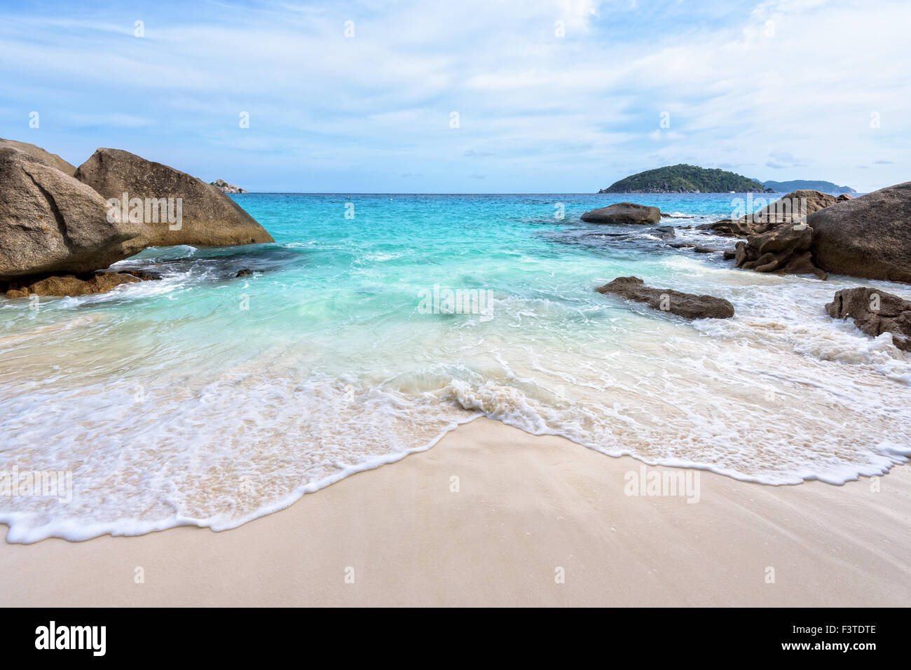 Beautiful nature of blue sea sand and white waves on small beach between rocks during summer at Koh Miang island in Mu Ko Simila Stock Photo