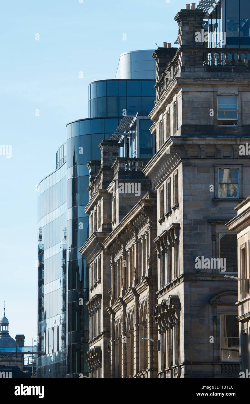 Modern Development juxtaposed against the stonework of the Old Post Office Building, Ingram Street, Glasgow Stock Photo