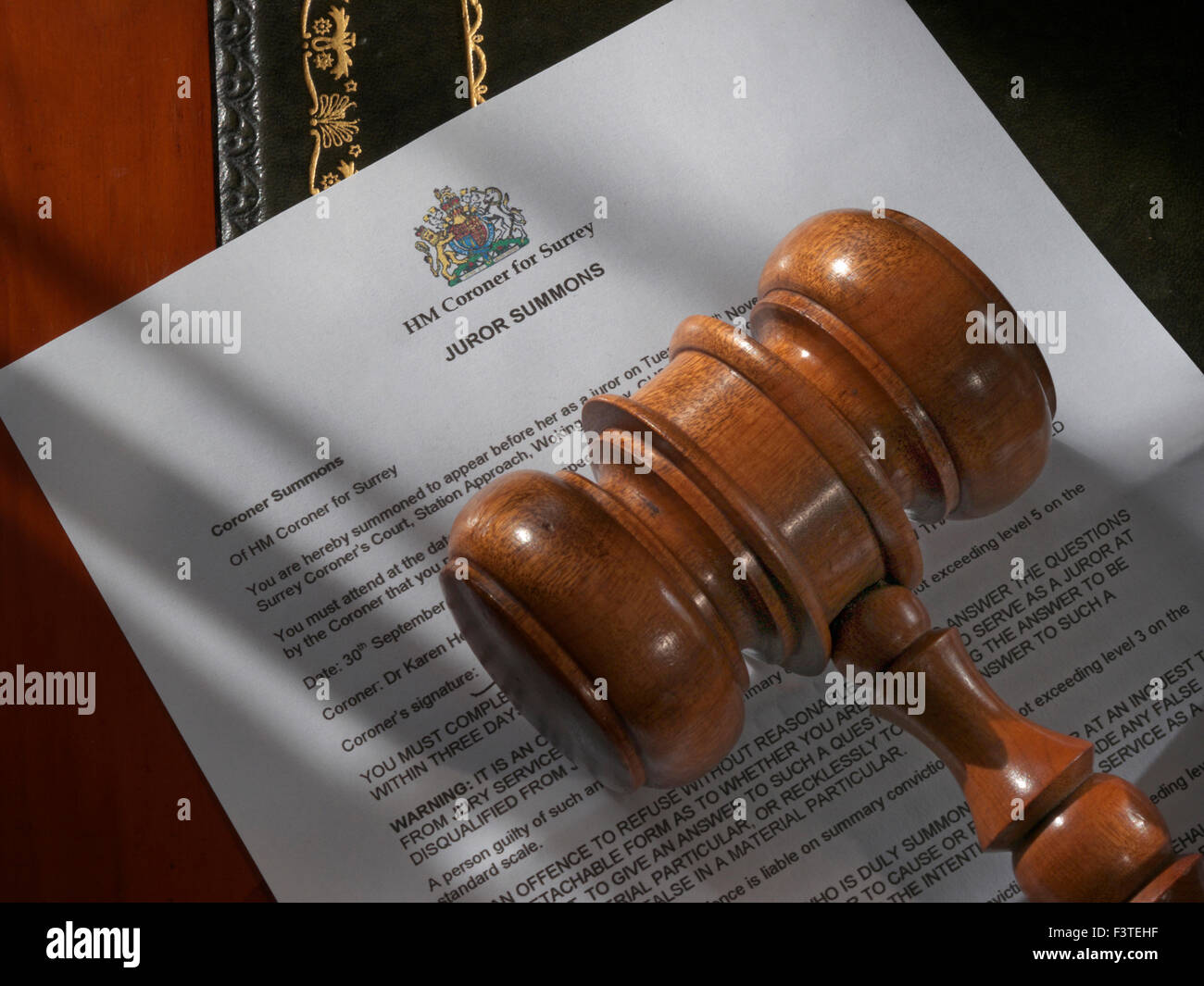JURY JUROR SUMMONS SERVICE LETTER Coroner Legal concept with Judges Court Gavel on Juror Summons letter from HM Coroner Surrey UK Stock Photo