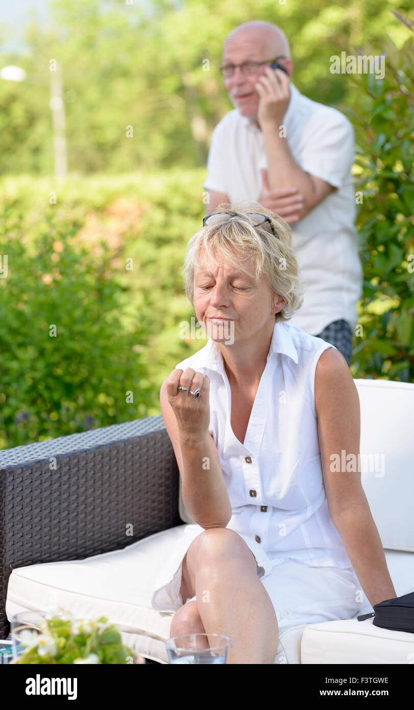 woman jealous of her husband, he phone Stock Photo