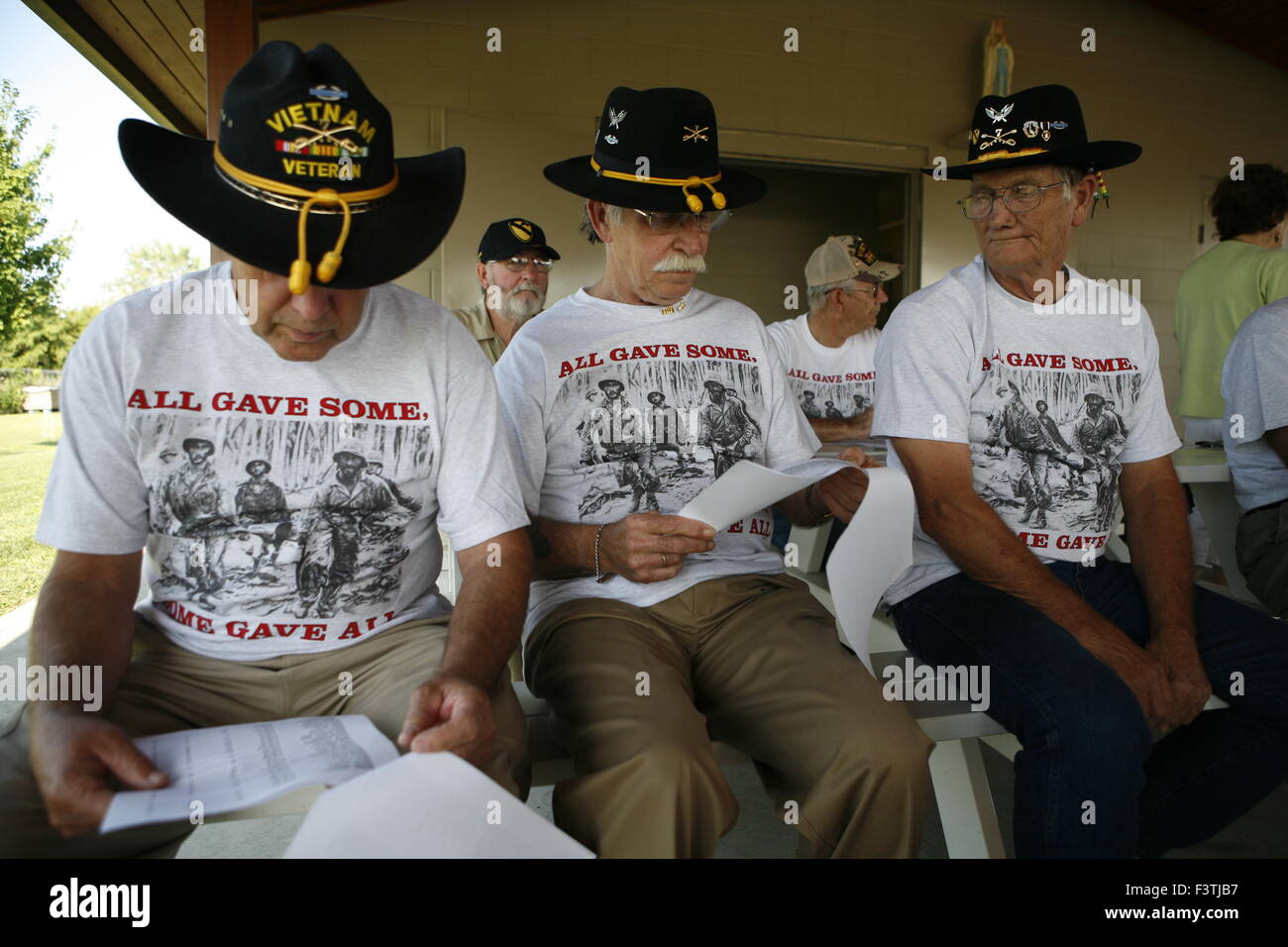 Vietnam Veterans of B Company, 7th Cavalry, who fought in the Battle of Ia Drang, and battles afterwards, read the names of their war dead during a memorial ceremony. Jack Zallen, who was in the cutoff platoon during the battle at LX Xray, is seated at center. Billy Smith, right, was a replacement after the battle and he fought in the Bon Song plain. Smith said one time his shirt was torn to shreds by bullets that passed over him during a battle in a cemetery that left the Cavalrymen pinned down.   B Co. 1/7th Cavalry Reunion in Effingham, Illinois. July 31-Aug2, 2009. Stock Photo