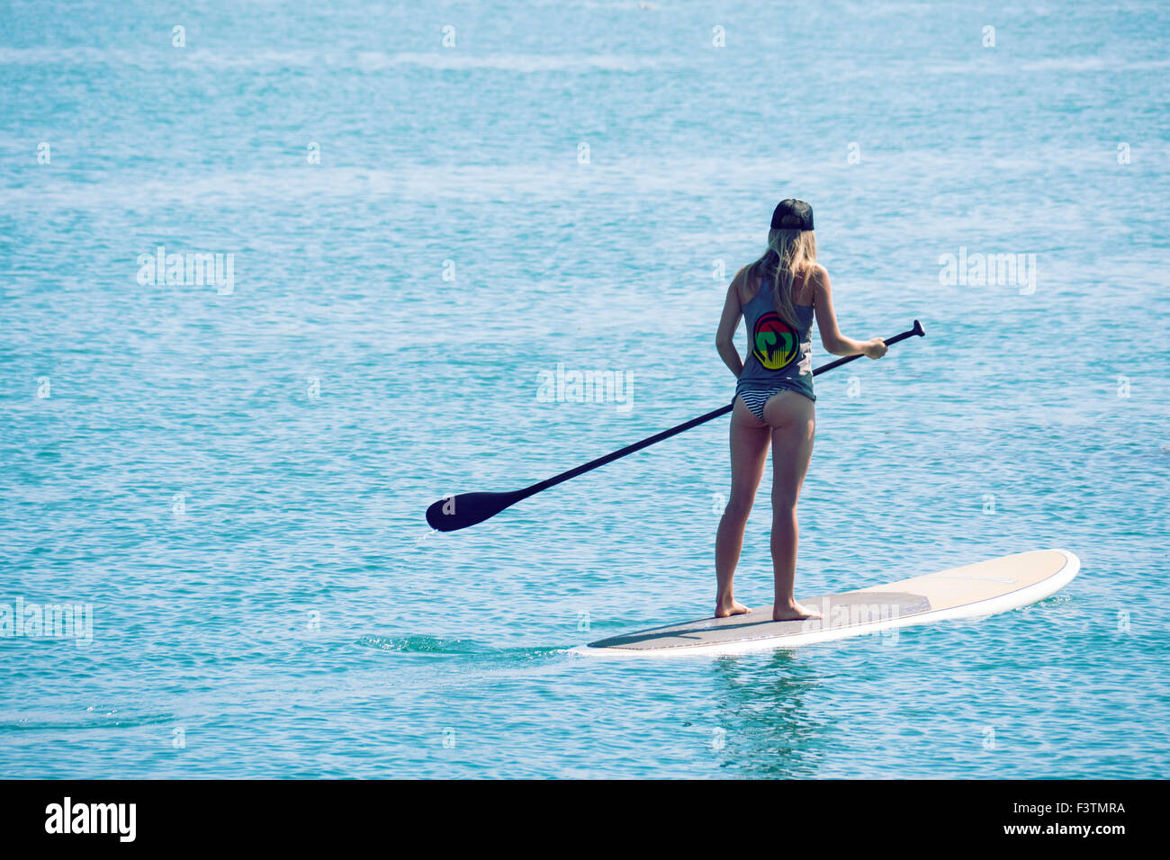 Young Woman paddle bording in Morro Bay California USA Stock Photo
