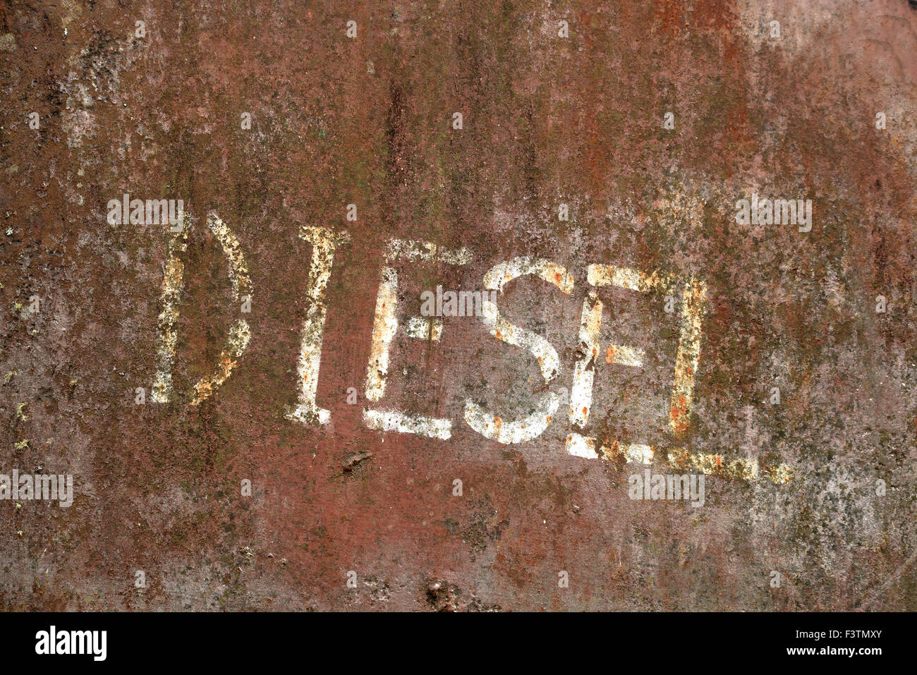 background of weathered diesel sign painted on a metal tank Stock Photo
