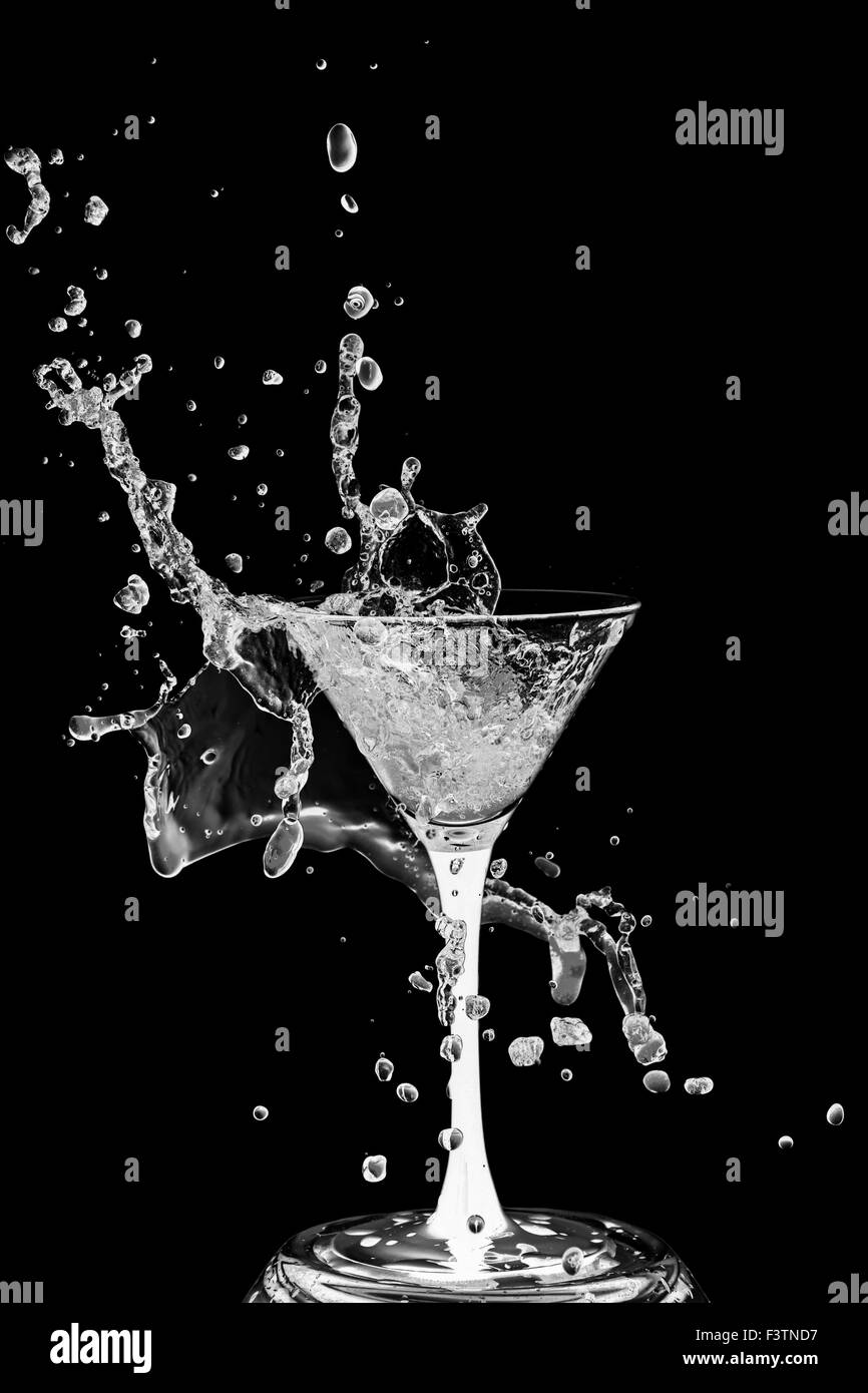 Abstract art. Cocktail glass with splashes of liquid isolated on a