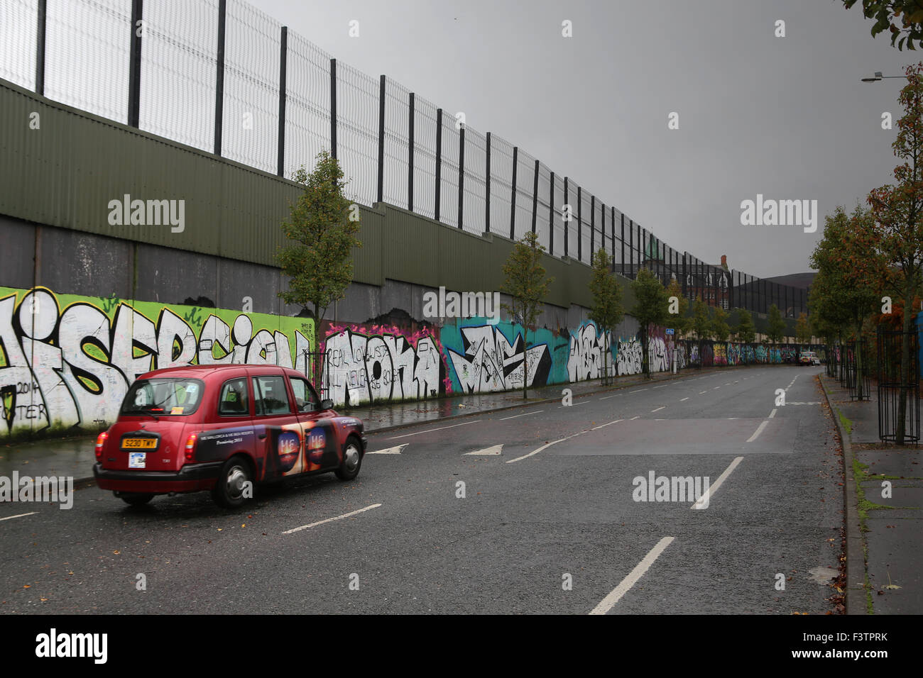 Cab along the 'peace line' in Cupar Way.Belfast,Northern Ireland Stock Photo