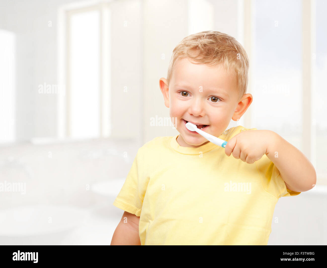 child brushing teeth in bathroom Stock Photo