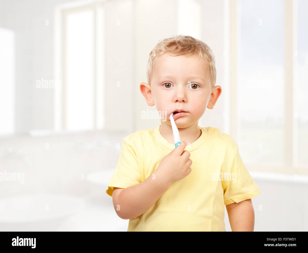 child brushing teeth in bathroom Stock Photo