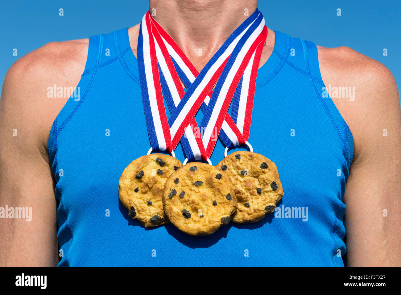 Athlete wearing chocolate chip cookies gold medals standing in front of