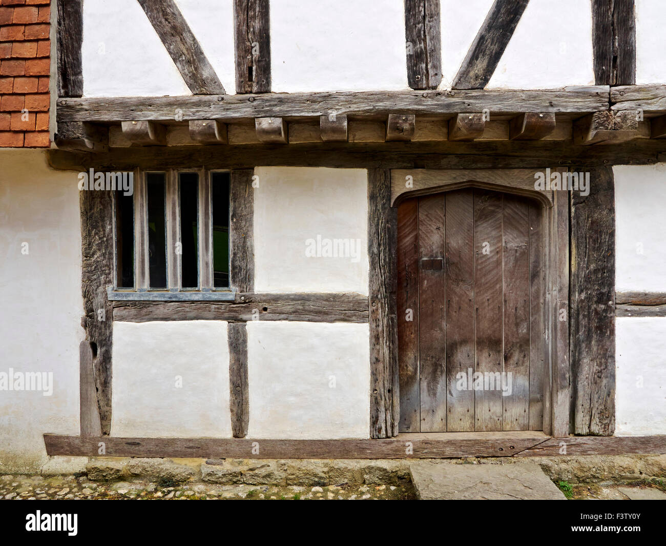 Detail of the front of an early Tudor (16th century) town house showing jettied upper floor & timber-framed construction. Stock Photo