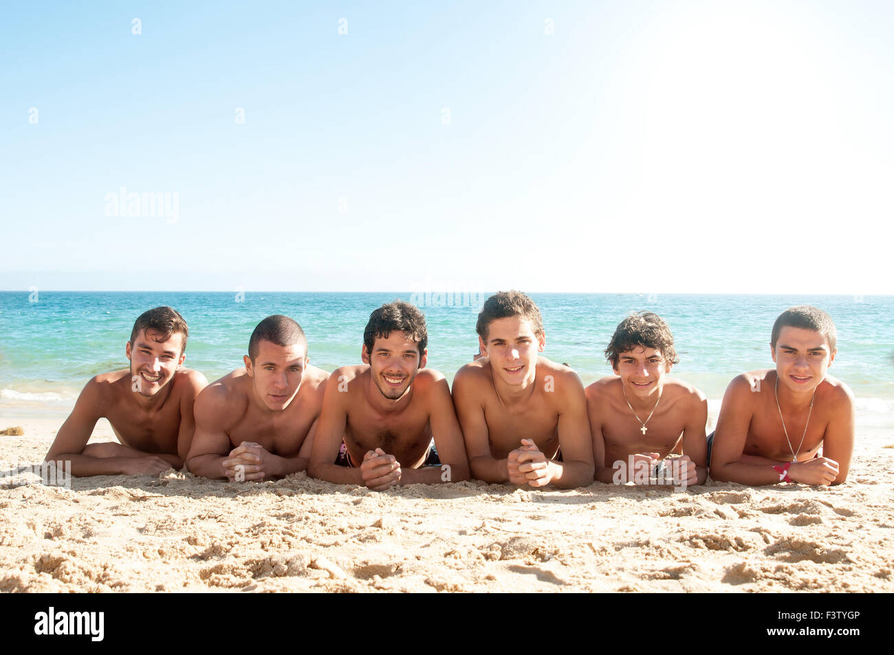 Group of happy boys at the beach Stock Photo